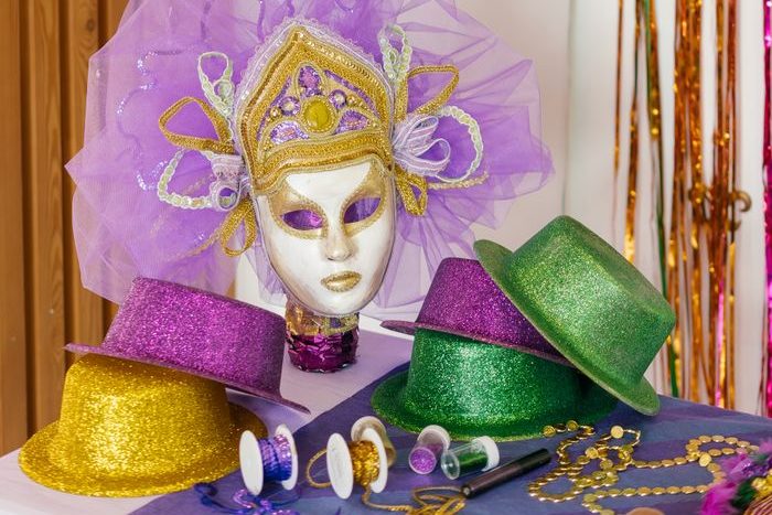 Vibrant carnival mask and hats with festive decorations, perfect for celebration themes.